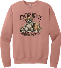 Diddly Squat crewneck sweatshirt in Mauve, featuring a cowboy raccoon lounging against a tree stump with The only squat I'm doing is diddly squat