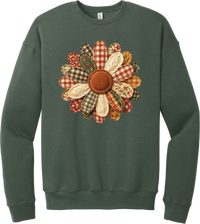 Patchwork Fabric Flower crewneck sweatshirt in Military Green, featuring an oversized fabric flower with plaid, gingham, calico, and cable knit petals around a stitched rust center