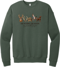 Hunting Season crewneck sweatshirt in Military Green, featuring a whitetail buck, antlers, a camo cap, a flying mallard, and a chocolate lab above Hunting Season My Favorite Season lettering