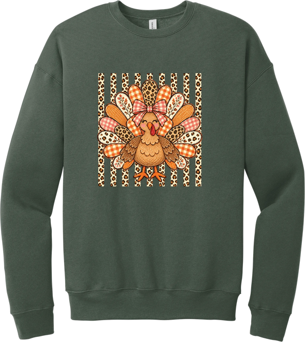 Preppy Turkey crewneck sweatshirt in Military Green, featuring a smiling turkey with gingham and leopard feathers and a pink bow on a leopard stripe background