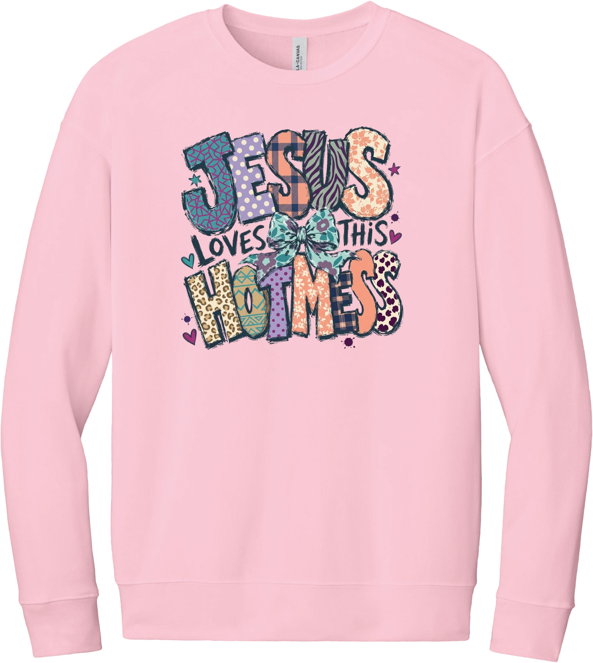Jesus Loves This Hot Mess crewneck sweatshirt in Pink, featuring patchwork Jesus Loves This Hot Mess lettering in leopard, plaid, polka dot, and zebra prints with a bow and hearts
