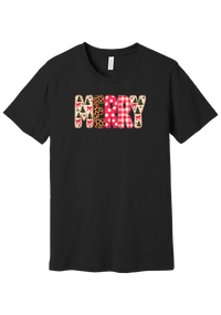 Merry Preppy Applique tee in Black, featuring faux applique MERRY letters in pink and green patchwork patterns with trees, gingham, Santas, polka dots, and candy cane stripes