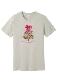 Adore Him Ribbon Tree tee in Dust, featuring a colorful ribbon Christmas tree topped with a hot pink bow over Oh Come Let Us Adore Him script