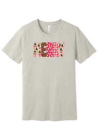 Merry Preppy Applique tee in Dust, featuring faux applique MERRY letters in pink and green patchwork patterns with trees, gingham, Santas, polka dots, and candy cane stripes