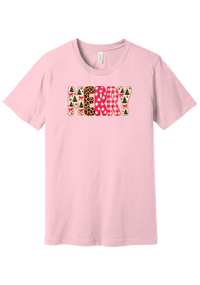 Merry Preppy Applique tee in Pink, featuring faux applique MERRY letters in pink and green patchwork patterns with trees, gingham, Santas, polka dots, and candy cane stripes