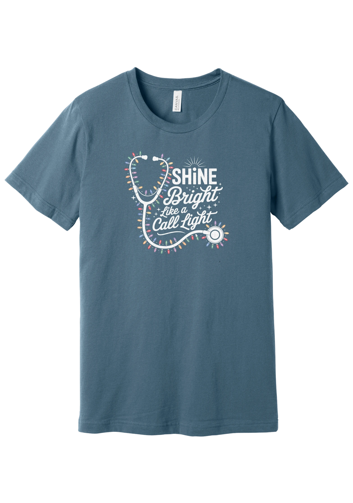 Shine Bright Like a Call Light tee in Steel Blue, featuring a white stethoscope wrapped in multicolor Christmas lights with bold Shine Bright Like a Call Light lettering