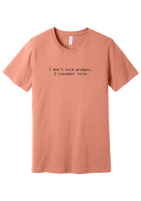 I Don't Hold Grudges tee in Sunset, featuring I don't hold grudges, I remember facts in distressed black typewriter letters