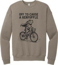 Off to Cause a Kerfuffle crewneck sweatshirt in Tan, featuring a caped frog riding a vintage bicycle with Off to cause a kerfuffle