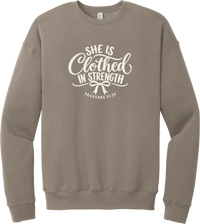 Clothed in Strength crewneck sweatshirt in Tan, featuring She Is Clothed in Strength in hand lettered script with a small bow and Proverbs 31:25