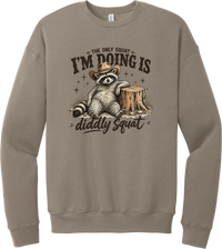 Diddly Squat crewneck sweatshirt in Tan, featuring a cowboy raccoon lounging against a tree stump with The only squat I'm doing is diddly squat