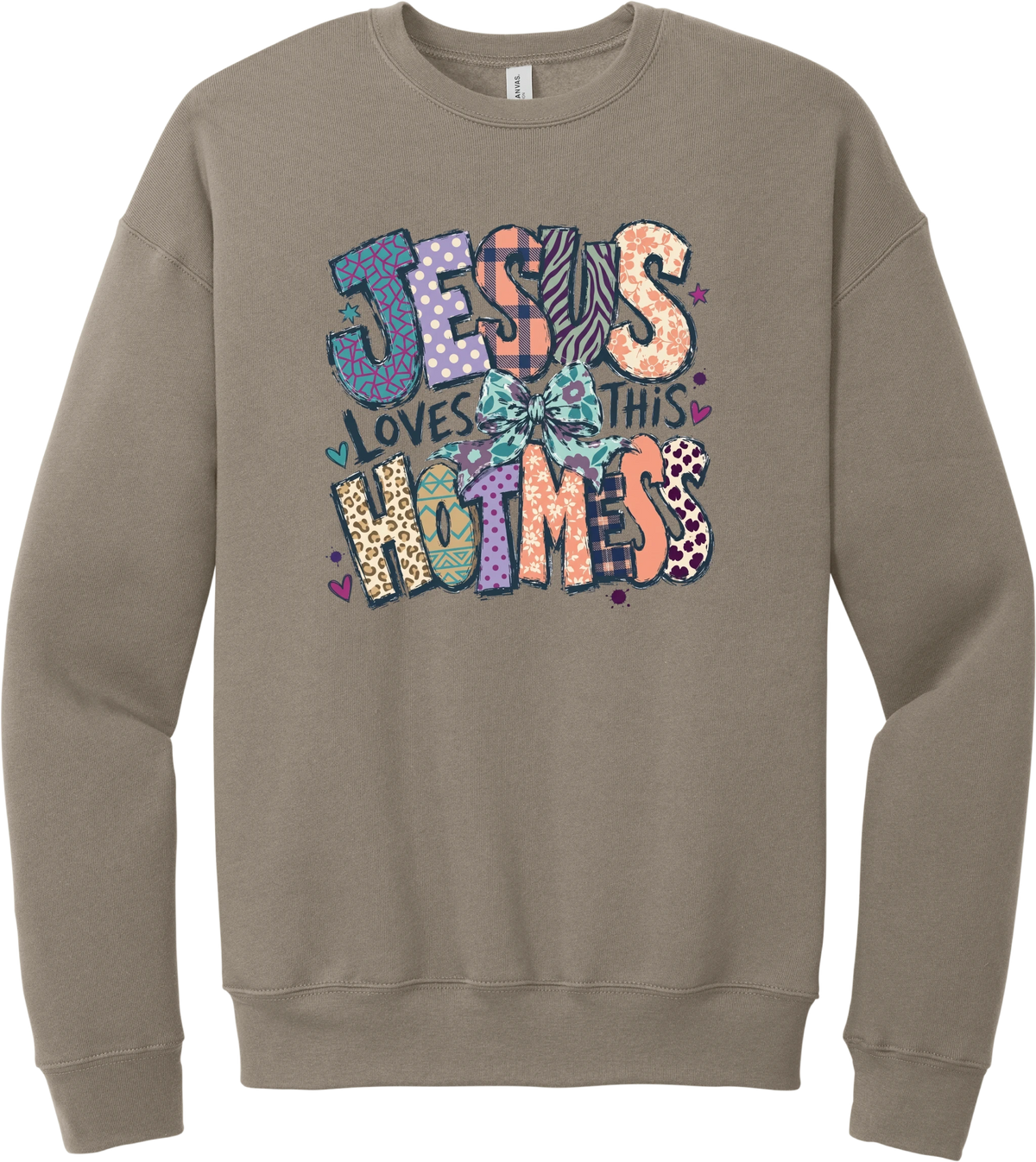 Jesus Loves This Hot Mess crewneck sweatshirt in Tan, featuring patchwork Jesus Loves This Hot Mess lettering in leopard, plaid, polka dot, and zebra prints with a bow and hearts