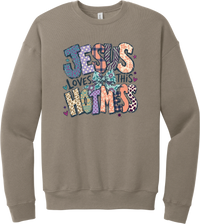 Jesus Loves This Hot Mess crewneck sweatshirt in Tan, featuring patchwork Jesus Loves This Hot Mess lettering in leopard, plaid, polka dot, and zebra prints with a bow and hearts