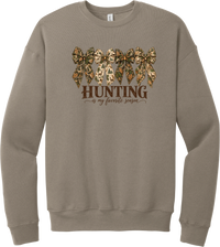 Hunting Is My Favorite Season crewneck sweatshirt in Tan, featuring four camo coquette bows with antlers, acorns, and deer above Hunting Is My Favorite Season lettering