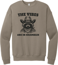 The Vibes Are in Shambles crewneck sweatshirt in Tan, featuring a cowboy raccoon in a bandana with The vibes are in shambles