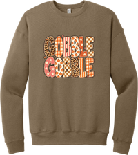 Gobble Gobble Patchwork crewneck sweatshirt in Vintage Brown, featuring Gobble Gobble in bubble letters filled with leopard, gingham, checkerboard, stars, and pumpkin prints